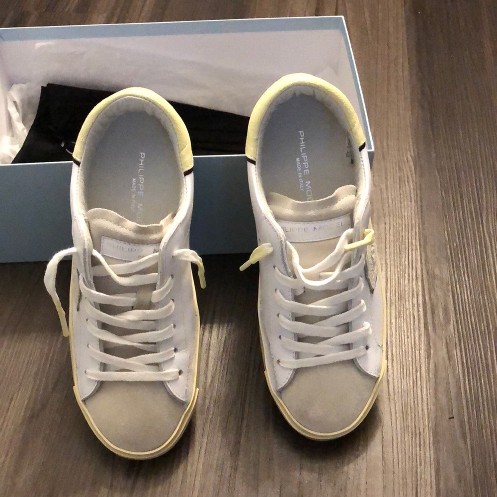 These are Philippe model Paris shoes that are white, yellow, and grey.